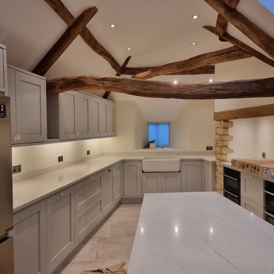 Newly fitted kitchen with exposed oak beams, recessed spotlights and under-cabinet lighting