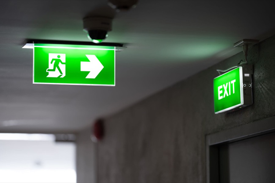 Green emergency exit lighting in a corridor